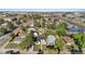 This aerial view showcases the property and surrounding neighborhood featuring mature trees and convenient access to the highway at 5640 Niagara St, Commerce City, CO 80022
