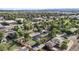 Panoramic aerial view showcasing the neighborhood's tree-lined streets and proximity to city skyline in the distance at 5640 Niagara St, Commerce City, CO 80022