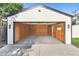 This oversized detached garage features an automatic door opener, interior lighting and a small work area at 5640 Niagara St, Commerce City, CO 80022