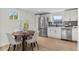 Bright kitchen with stainless steel appliances, white cabinets and a dining table for a modern, inviting space at 5640 Niagara St, Commerce City, CO 80022