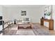 Comfortable living room with eclectic decor, natural light and hardwood floors at 5640 Niagara St, Commerce City, CO 80022