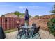 A fenced in backyard featuring patio furniture and a fun flamingo decoration at 1150 Inca St # 43, Denver, CO 80204