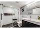 Modern bathroom featuring a glass shower with a bench, sleek fixtures, and contrasting tile accents at 1150 Inca St # 43, Denver, CO 80204