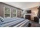 Cozy bedroom features natural light from the windows, landscape art, and a TV at 1150 Inca St # 43, Denver, CO 80204