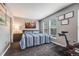 Comfortable bedroom features natural light from the windows, cityscape art, and an exercise bike at 1150 Inca St # 43, Denver, CO 80204