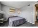 Serene bedroom features neutral tones, a stylish bedside lamp, and a soothing ambiance at 1150 Inca St # 43, Denver, CO 80204