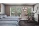 Comfortable bedroom features natural light from the windows, landscape art, and an exercise bike at 1150 Inca St # 43, Denver, CO 80204