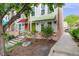 Home exterior featuring a green awning covered front porch with lush green landscaping at 1150 Inca St # 43, Denver, CO 80204