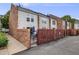 Townhome's exterior showcases a fenced patio with a gate leading to the walkway at 1150 Inca St # 43, Denver, CO 80204