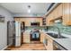 Modern kitchen with stainless steel appliances, light wood cabinets, and stylish tile backsplash at 1150 Inca St # 43, Denver, CO 80204