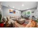 Comfortable living room with a large sectional sofa, modern artwork, and bright natural light at 1150 Inca St # 43, Denver, CO 80204
