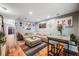 Bright living room with a large sectional sofa, unique artwork, hardwood floors, and a stylish accent rug at 1150 Inca St # 43, Denver, CO 80204
