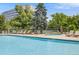 Relax by the refreshing pool with lounge chairs, lush landscaping, and a calming atmosphere at 1150 Inca St # 43, Denver, CO 80204