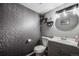 Stylish powder room with elegant wallpaper, modern lighting, and a sleek vanity at 1150 Inca St # 43, Denver, CO 80204