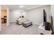 Finished basement featuring a comfy sitting area with couch and TV at 15149 E Princeton Pl # D, Aurora, CO 80014
