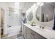 Modern bathroom featuring a double vanity, tub-shower combo with marble tile, and sleek fixtures at 15149 E Princeton Pl # D, Aurora, CO 80014