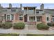 Charming townhome with a mix of brick and siding, complemented by well-manicured bushes, enhancing its curb appeal at 15149 E Princeton Pl # D, Aurora, CO 80014