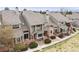 Exterior elevation showing multi-story townhomes with brick and siding at 15149 E Princeton Pl # D, Aurora, CO 80014