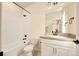 Bright bathroom with modern fixtures, white tiled shower and vanity with ample storage at 8055 Navajo River Loop # B, Littleton, CO 80125