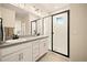 Modern bathroom features a double vanity, a glass-enclosed shower, and stylish fixtures at 8055 Navajo River Loop # B, Littleton, CO 80125