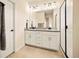 Contemporary bathroom features double sinks, modern lighting, and glass enclosed shower at 8055 Navajo River Loop # B, Littleton, CO 80125