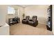 Bonus room has recliners, a desk, and large window with natural light at 8055 Navajo River Loop # B, Littleton, CO 80125