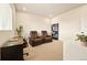 Versatile bonus room with theater seating, a desk, and space for entertainment or hobbies at 8055 Navajo River Loop # B, Littleton, CO 80125