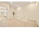 Open hallway with a staircase and neutral carpet and bright walls at 8055 Navajo River Loop # B, Littleton, CO 80125