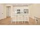 Bright white kitchen with island, stainless steel appliances, and modern finishes at 8055 Navajo River Loop # B, Littleton, CO 80125