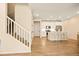 View of open concept living space with stairwell and kitchen with barstool seating at 8055 Navajo River Loop # B, Littleton, CO 80125