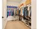 Spacious walk-in closet offers ample storage with shelves and rods for clothing and accessories at 8055 Navajo River Loop # B, Littleton, CO 80125