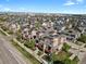 Aerial view of residential area with townhomes featuring solar panels on rooftops at 8187 Martin Luther King Blvd, Denver, CO 80238