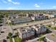 Aerial view of townhomes near retail area with solar panels on the roof at 8187 Martin Luther King Blvd, Denver, CO 80238