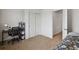 Neutral bedroom with carpeted floors, a large closet, and a desk with shelves at 8187 Martin Luther King Blvd, Denver, CO 80238