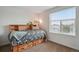 Cozy bedroom features carpeted floors and a bed with storage drawers beneath at 8187 Martin Luther King Blvd, Denver, CO 80238