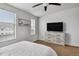 Well lit bedroom with a ceiling fan, large windows, and carpeted floors at 8187 Martin Luther King Blvd, Denver, CO 80238