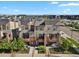 Modern townhome with orange accents and solar panels in a suburban neighborhood at 8187 Martin Luther King Blvd, Denver, CO 80238