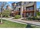Attractive townhome row with landscaped front yards, sidewalks, and inviting entrances at 8187 Martin Luther King Blvd, Denver, CO 80238