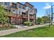Modern townhome exterior featuring a well-maintained lawn and a neatly landscaped entrance at 8187 Martin Luther King Blvd, Denver, CO 80238
