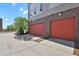 Two-car attached garage, cement driveway, and partial landscaping at 8187 Martin Luther King Blvd, Denver, CO 80238