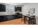 Well-appointed kitchen with dark cabinetry, granite countertops, and stainless steel appliances at 8187 Martin Luther King Blvd, Denver, CO 80238