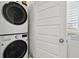Laundry room includes stacked washer and dryer with a nearby window for natural light at 8187 Martin Luther King Blvd, Denver, CO 80238