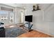 Modern living room with sleek TV stand, area rug, and easy access to outdoor space at 8187 Martin Luther King Blvd, Denver, CO 80238