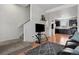 Comfortable living room open to the kitchen and staircase with a sleek, modern decor at 8187 Martin Luther King Blvd, Denver, CO 80238