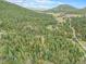 Breathtaking aerial shot of land with majestic mountains, trees and a clear blue sky at 10142 S Turkey Creek Rd, Morrison, CO 80465