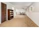 Finished basement showcasing plush carpet, built-in shelving, and a dining area at 10142 S Turkey Creek Rd, Morrison, CO 80465
