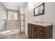 Modern bathroom with a glass-doored shower, wood-style vanity, and marble-like tile at 10142 S Turkey Creek Rd, Morrison, CO 80465