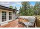 Back deck featuring a hot tub, outdoor furniture, and wooded views at 10142 S Turkey Creek Rd, Morrison, CO 80465