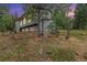 Two-story grey home featuring a tree swing and nestled in a tranquil, wooded setting at 10142 S Turkey Creek Rd, Morrison, CO 80465