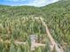Inviting home nestled among tall trees, boasting a long, private driveway and tranquil setting at 10142 S Turkey Creek Rd, Morrison, CO 80465